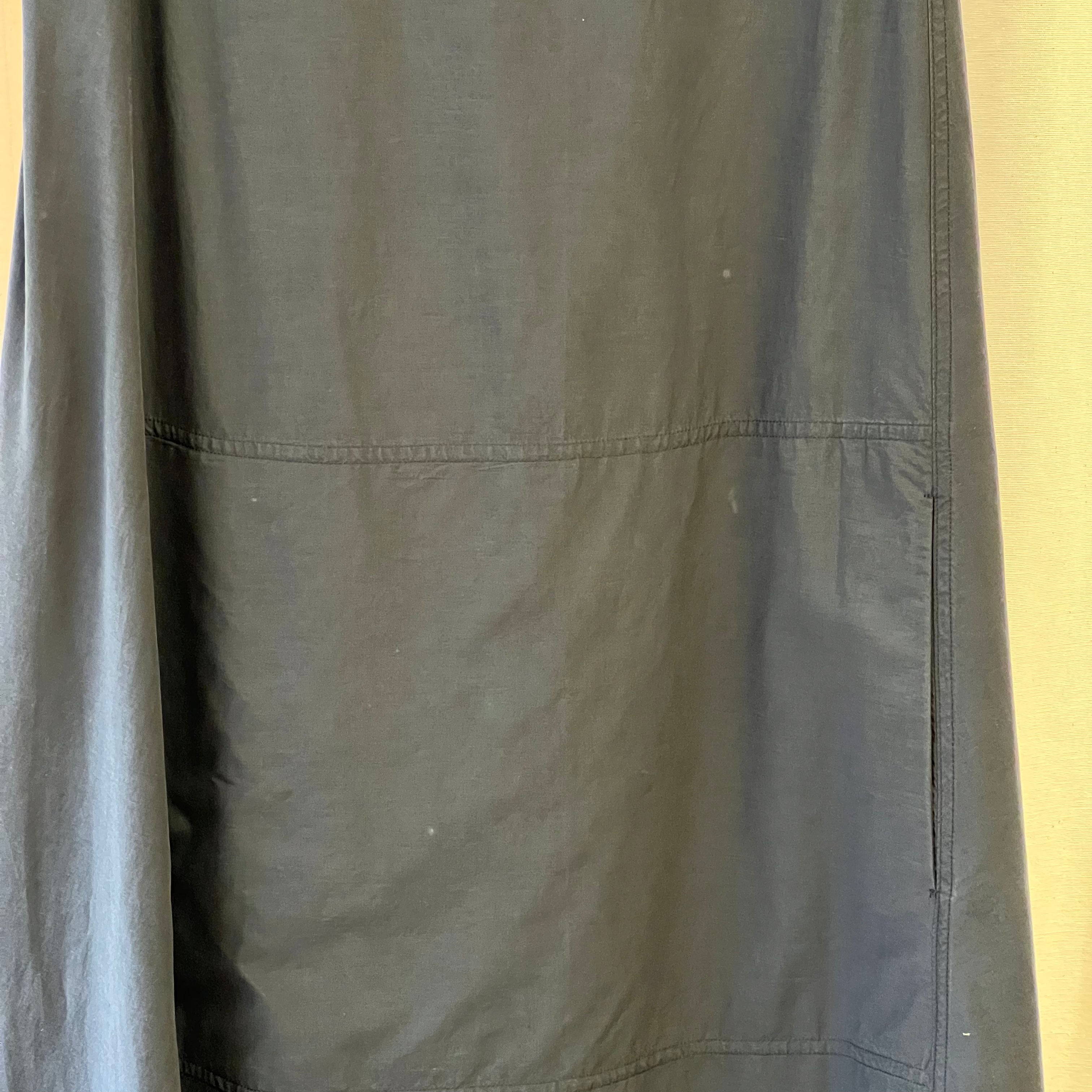 Close-up of a dark gray fabric with visible texture and stitching.