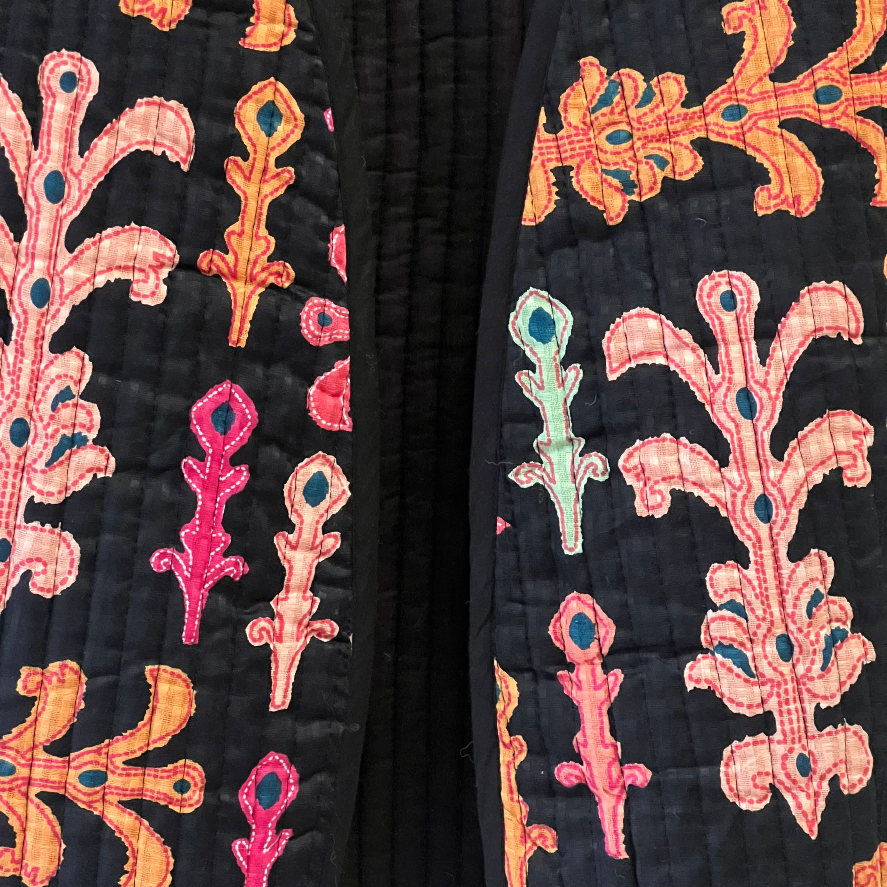 Close-up of a black fabric with colorful embroidered patterns