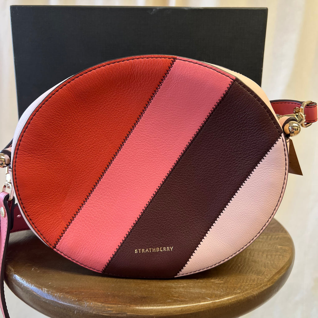 Strathberry pink toned across body oval shaped bag