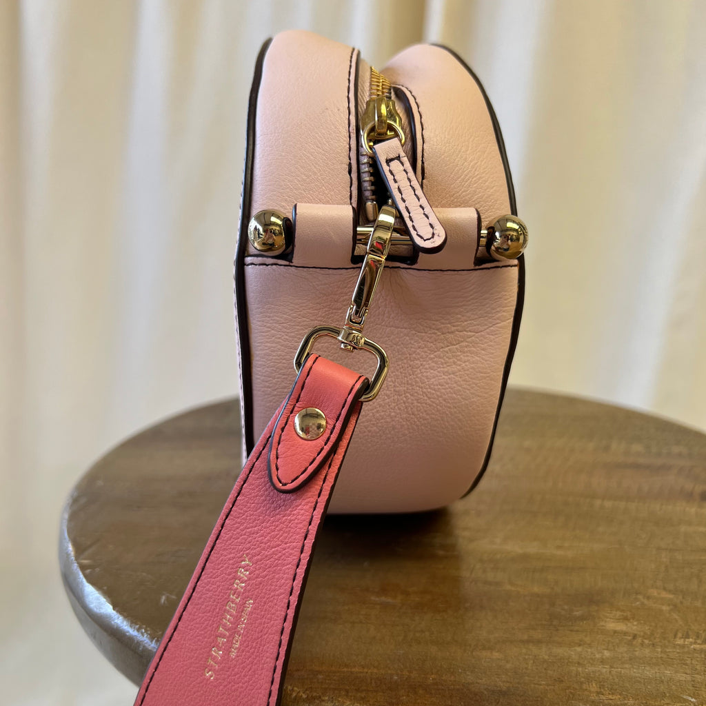 Strathberry pink toned across body oval shaped bag