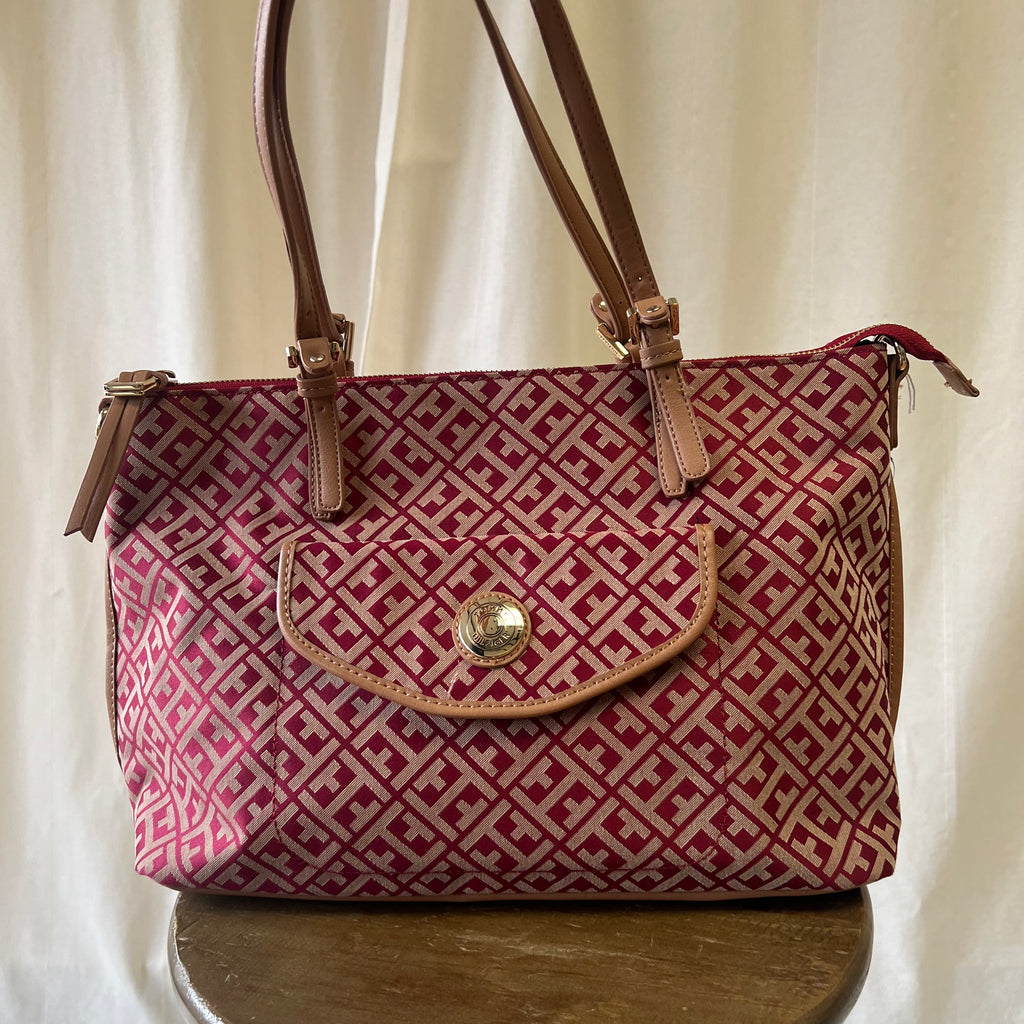 Red and beige patterned handbag with brown straps on a white background