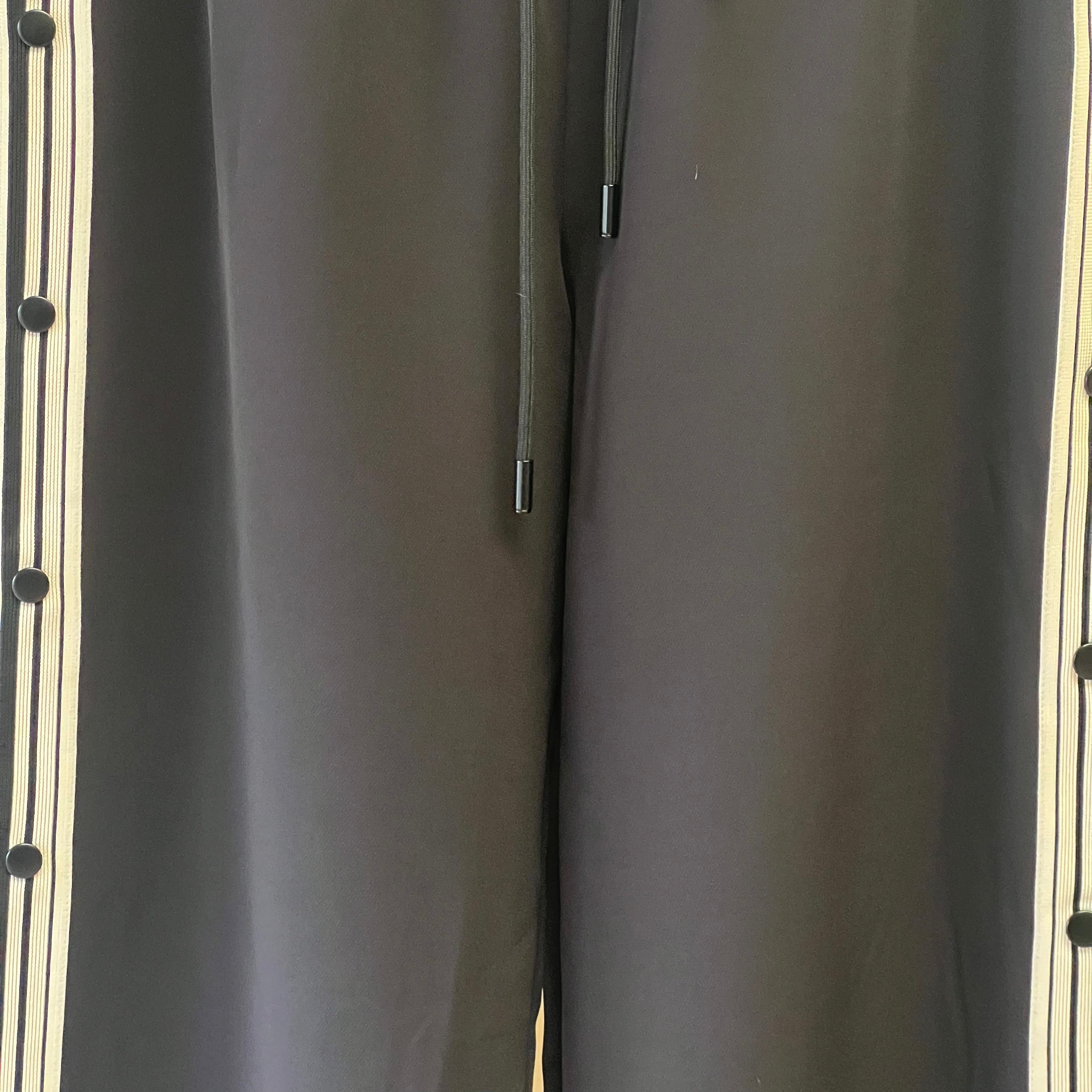 Close-up of a gray fabric surface with a zipper and buttons.