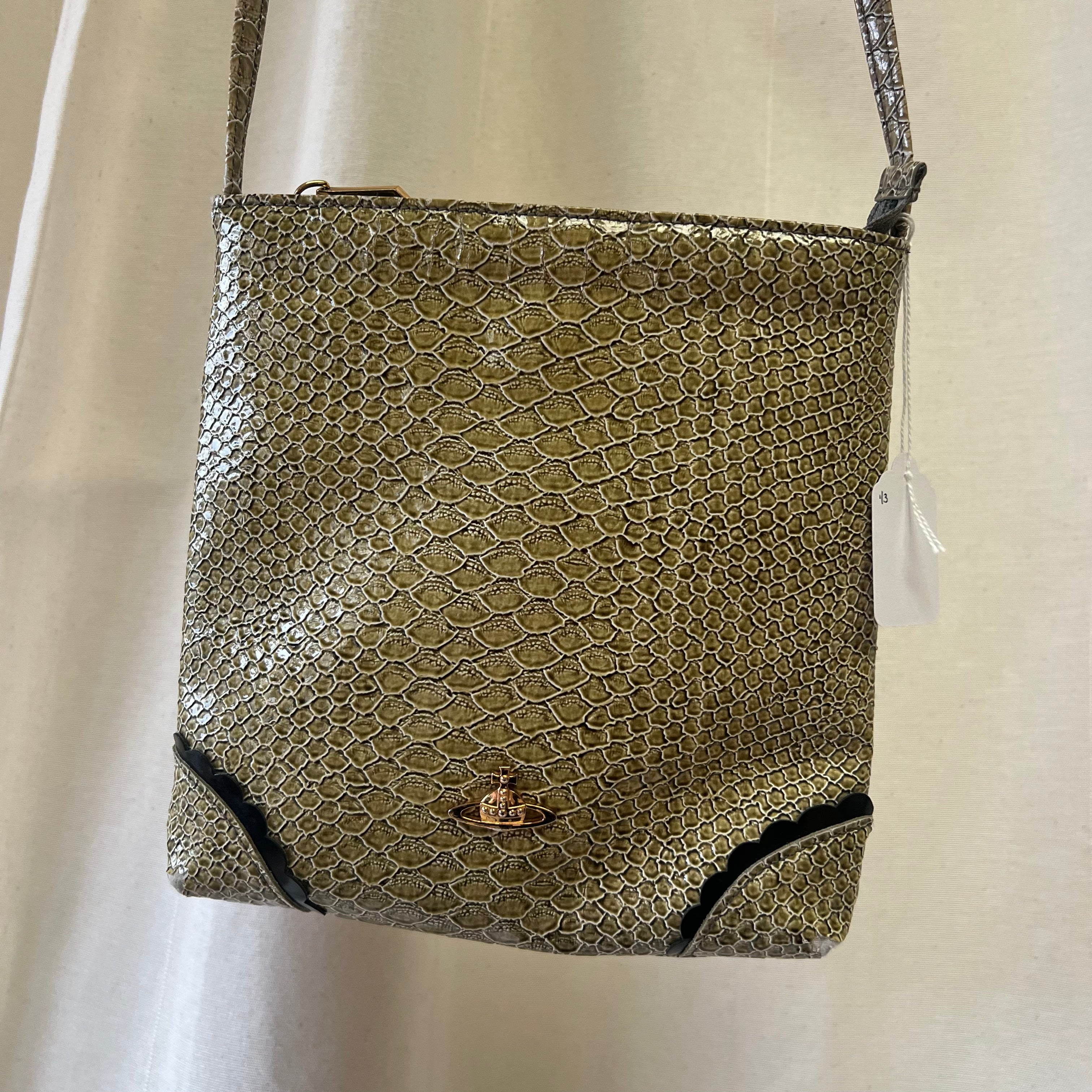 Snakeskin textured handbag with a visible brand logo on a white background