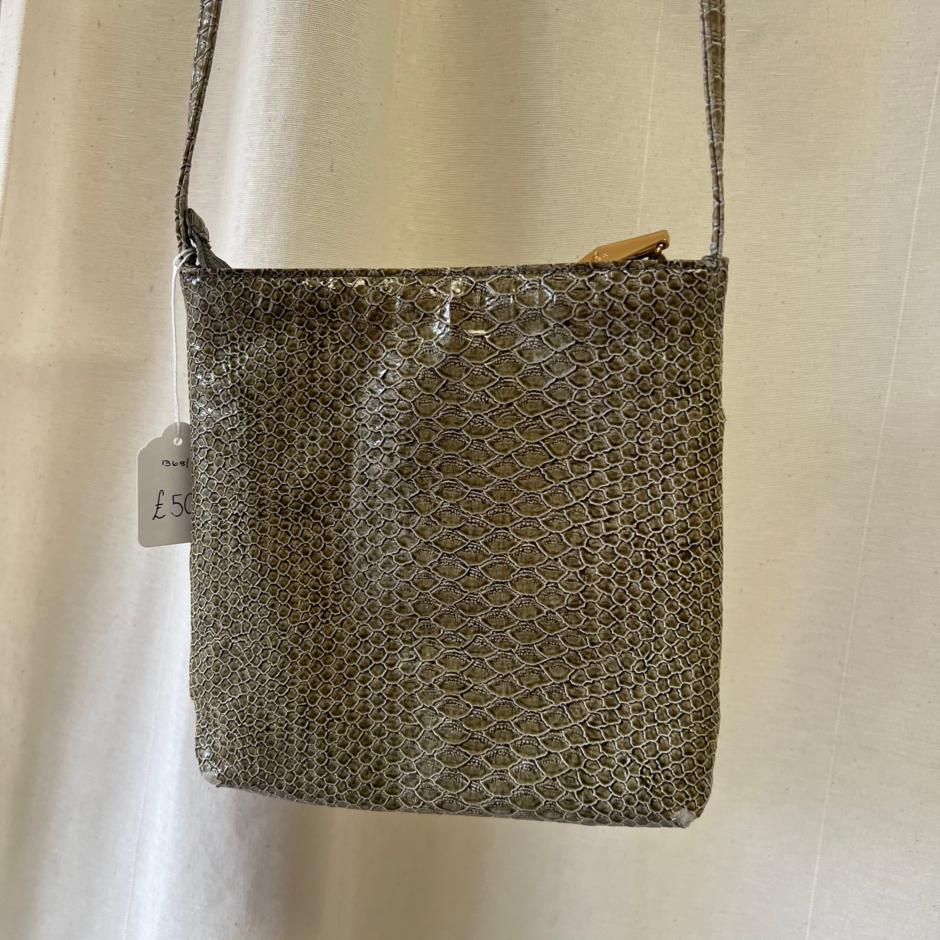 Textured handbag with a visible tag on a plain background